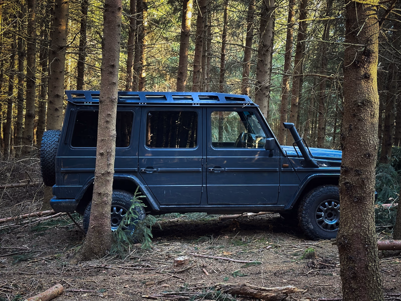 Blue G-Class with Walger Works roof rack between trees